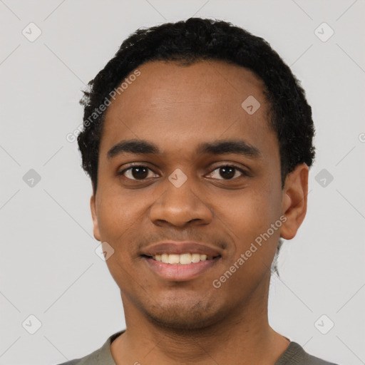 Joyful black young-adult male with short  black hair and brown eyes