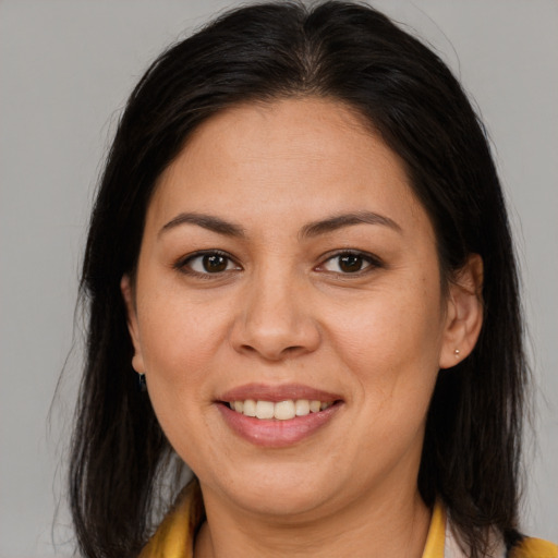 Joyful latino young-adult female with medium  brown hair and brown eyes