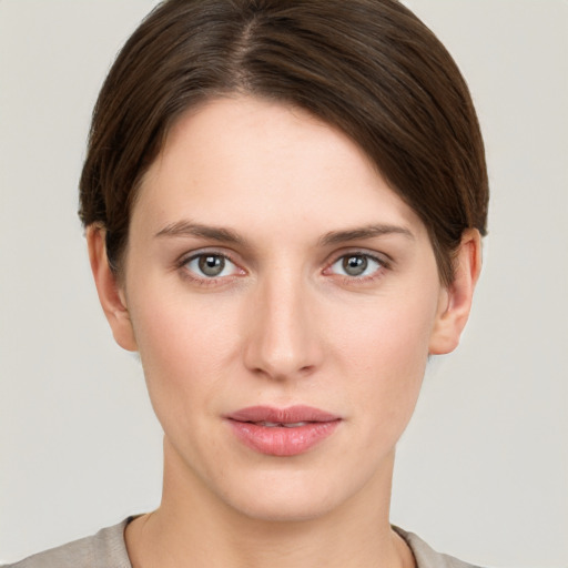 Joyful white young-adult female with short  brown hair and grey eyes