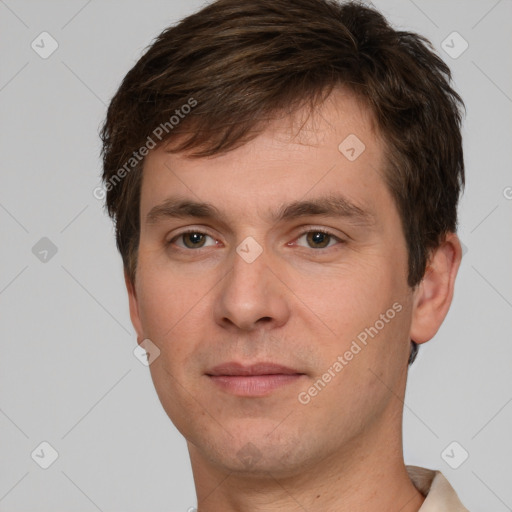 Joyful white young-adult male with short  brown hair and grey eyes