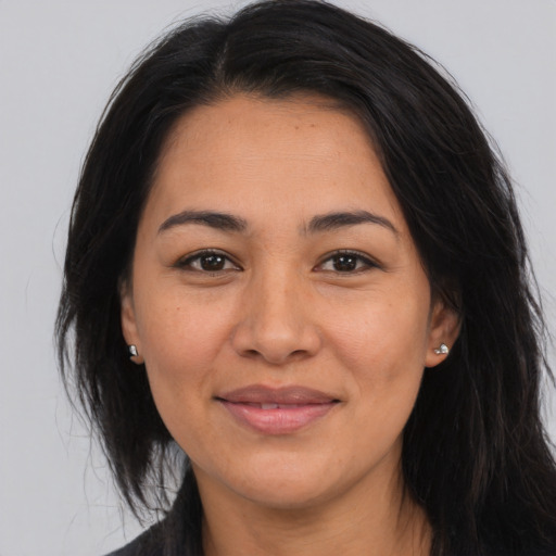 Joyful asian young-adult female with long  brown hair and brown eyes