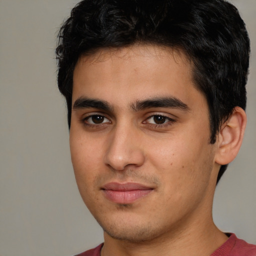 Joyful latino young-adult male with short  brown hair and brown eyes