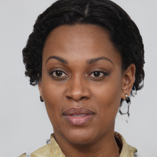 Joyful black adult female with short  brown hair and brown eyes