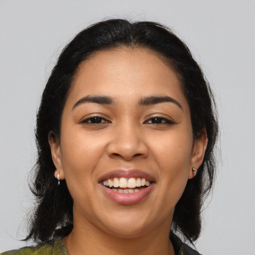 Joyful latino young-adult female with medium  brown hair and brown eyes
