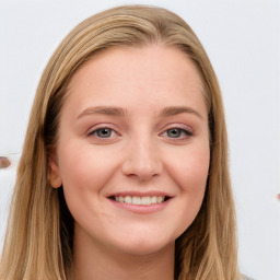 Joyful white young-adult female with long  brown hair and blue eyes