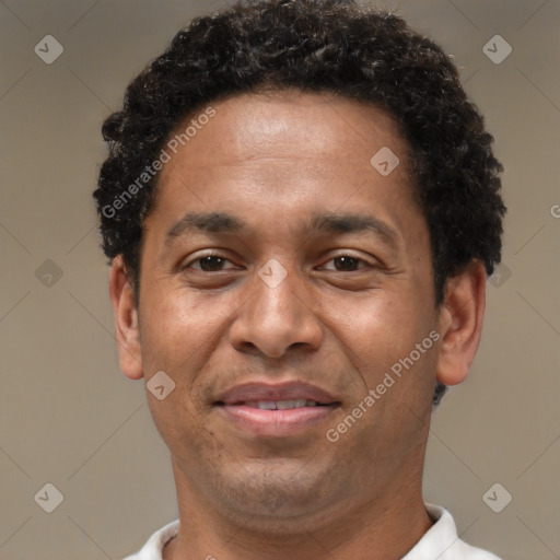 Joyful latino adult male with short  brown hair and brown eyes