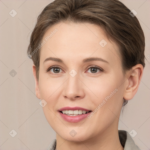 Joyful white young-adult female with short  brown hair and grey eyes