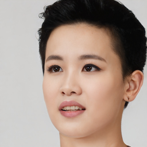 Joyful asian young-adult female with short  black hair and brown eyes