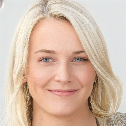 Joyful white young-adult female with long  blond hair and blue eyes