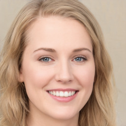 Joyful white young-adult female with long  brown hair and green eyes