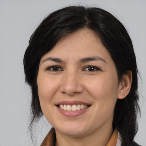 Joyful asian adult female with medium  brown hair and brown eyes