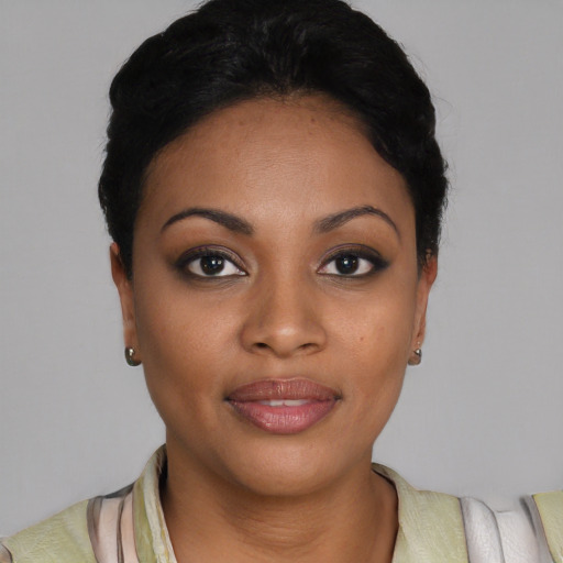 Joyful black young-adult female with short  black hair and brown eyes