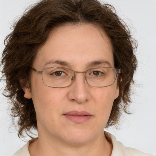 Joyful white adult female with medium  brown hair and green eyes