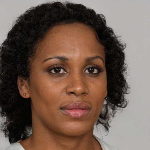 Neutral black young-adult female with medium  brown hair and brown eyes