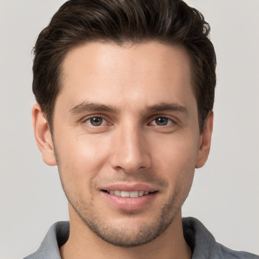 Joyful white young-adult male with short  brown hair and brown eyes