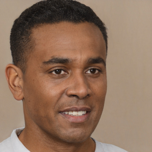 Joyful black young-adult male with short  brown hair and brown eyes