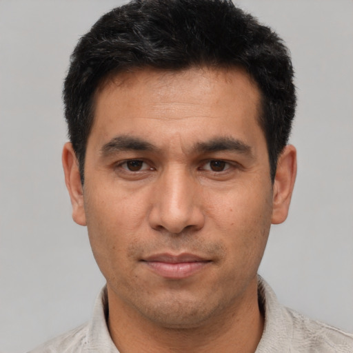 Joyful asian young-adult male with short  black hair and brown eyes