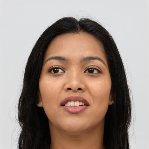 Joyful latino young-adult female with long  black hair and brown eyes
