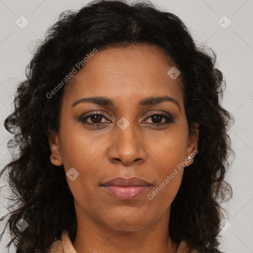 Joyful black adult female with long  brown hair and brown eyes