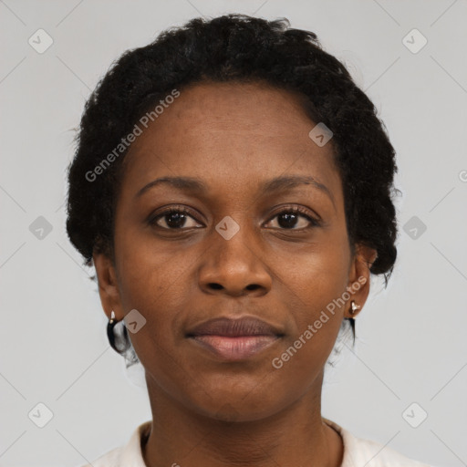 Joyful black adult female with short  brown hair and brown eyes