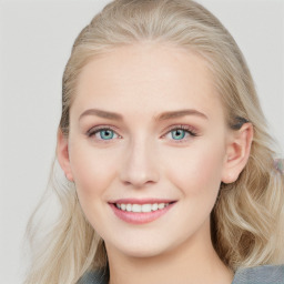 Joyful white young-adult female with long  brown hair and blue eyes