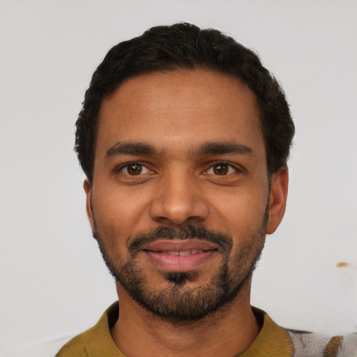 Joyful latino young-adult male with short  black hair and brown eyes
