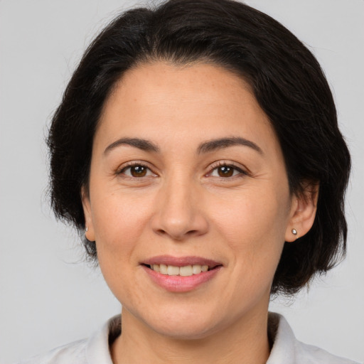 Joyful white adult female with medium  brown hair and brown eyes