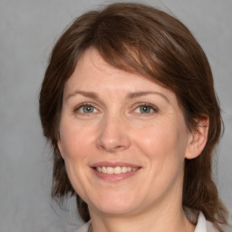 Joyful white adult female with medium  brown hair and grey eyes