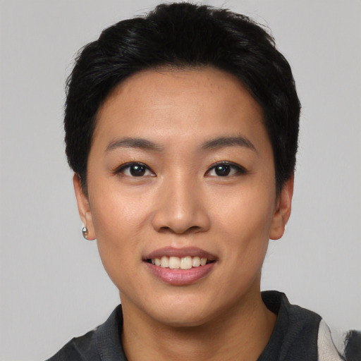 Joyful asian young-adult female with short  black hair and brown eyes