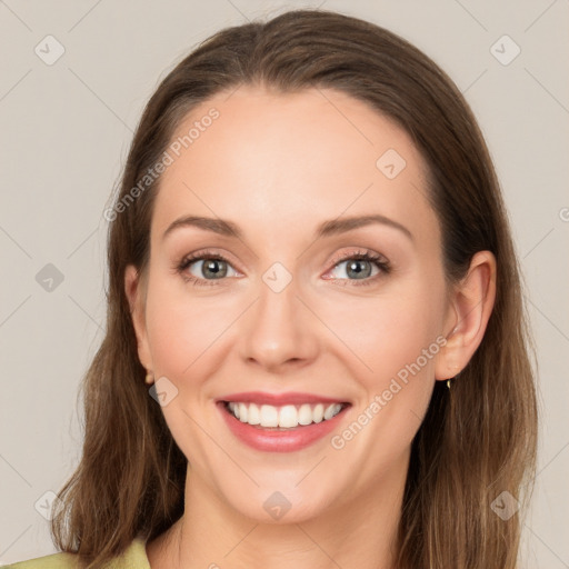 Joyful white young-adult female with long  brown hair and green eyes