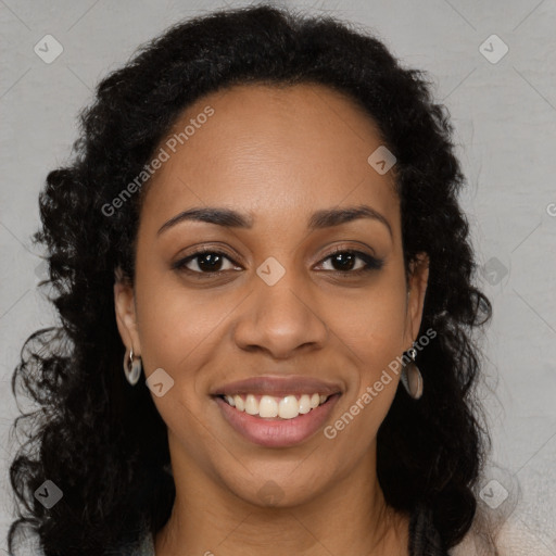 Joyful black young-adult female with long  brown hair and brown eyes