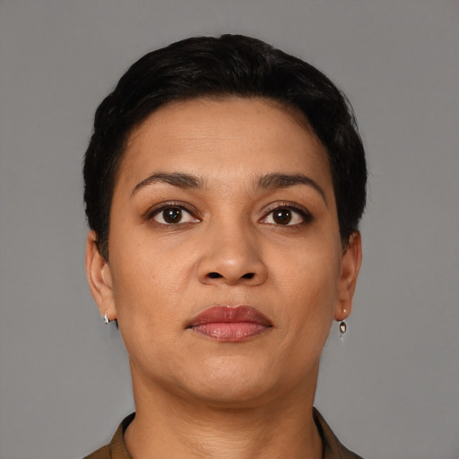 Joyful latino young-adult female with short  black hair and brown eyes
