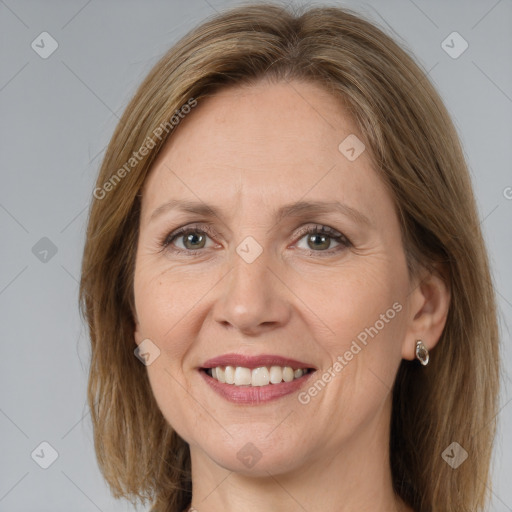 Joyful white adult female with long  brown hair and grey eyes