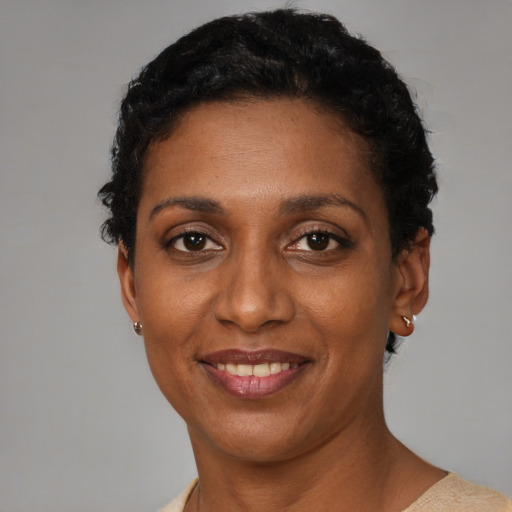 Joyful black adult female with short  black hair and brown eyes