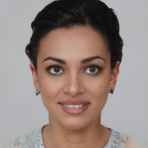 Joyful latino young-adult female with short  brown hair and brown eyes