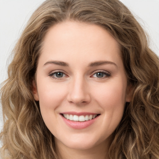 Joyful white young-adult female with long  brown hair and green eyes