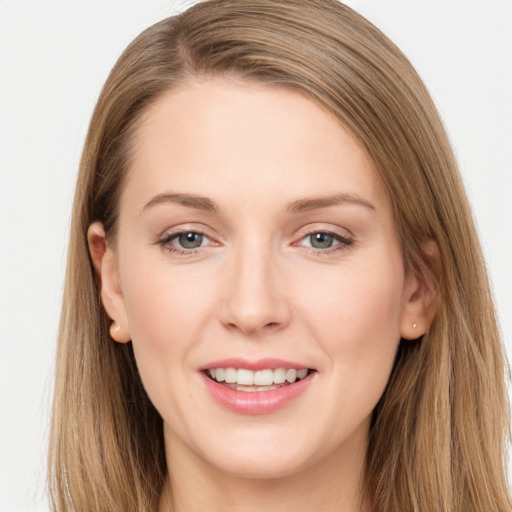 Joyful white young-adult female with long  brown hair and grey eyes