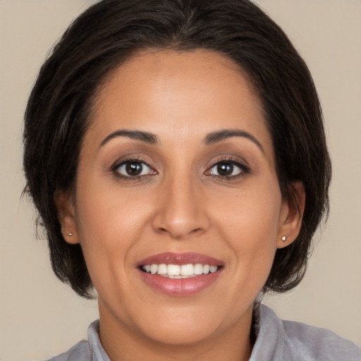 Joyful white young-adult female with medium  brown hair and brown eyes