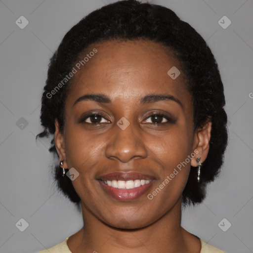 Joyful black young-adult female with short  black hair and brown eyes