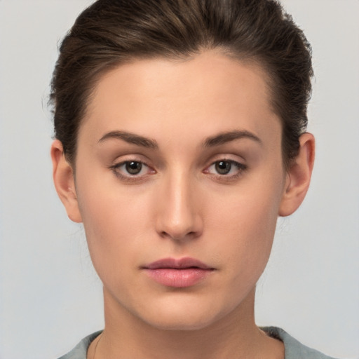 Neutral white young-adult female with short  brown hair and brown eyes