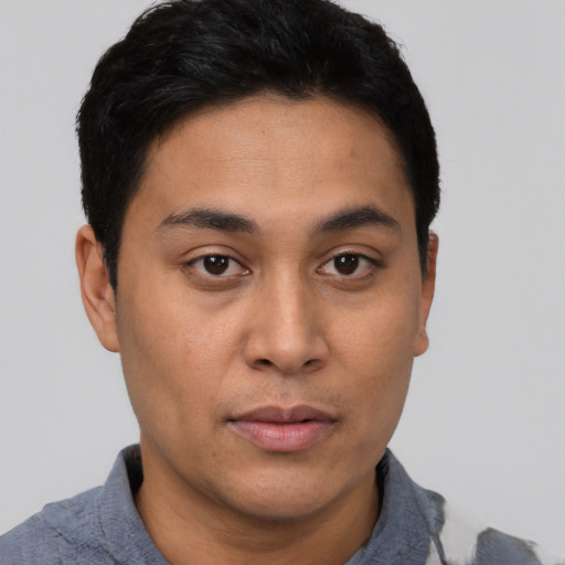 Neutral latino young-adult male with short  black hair and brown eyes