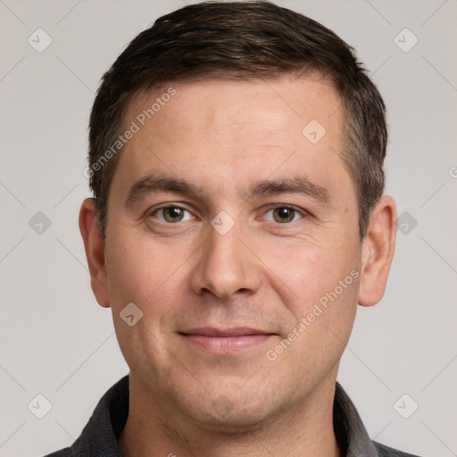 Joyful white adult male with short  brown hair and grey eyes