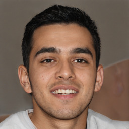 Joyful latino young-adult male with short  black hair and brown eyes