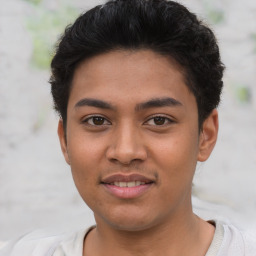 Joyful latino young-adult male with short  brown hair and brown eyes