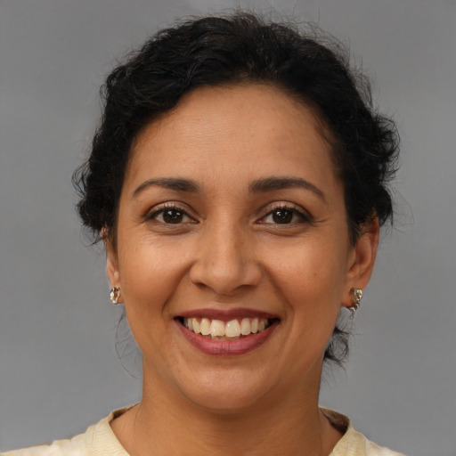 Joyful latino young-adult female with short  brown hair and brown eyes