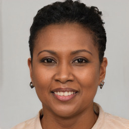 Joyful black young-adult female with short  brown hair and brown eyes