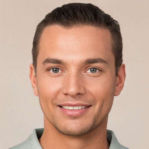 Joyful white young-adult male with short  brown hair and brown eyes