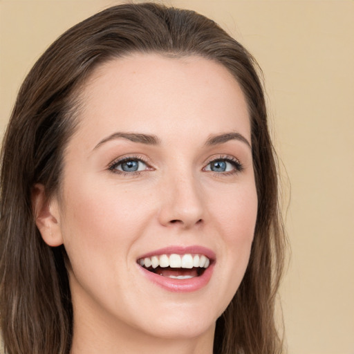 Joyful white young-adult female with long  brown hair and brown eyes