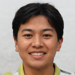 Joyful asian young-adult male with short  brown hair and brown eyes