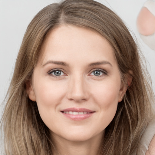 Joyful white young-adult female with long  brown hair and grey eyes